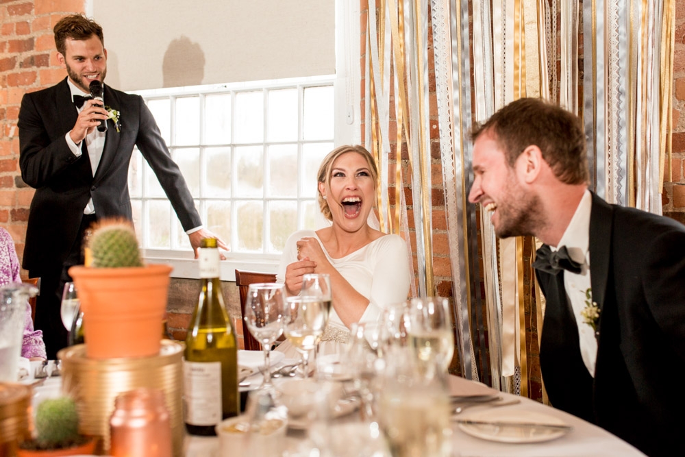 bride laughing during speeches