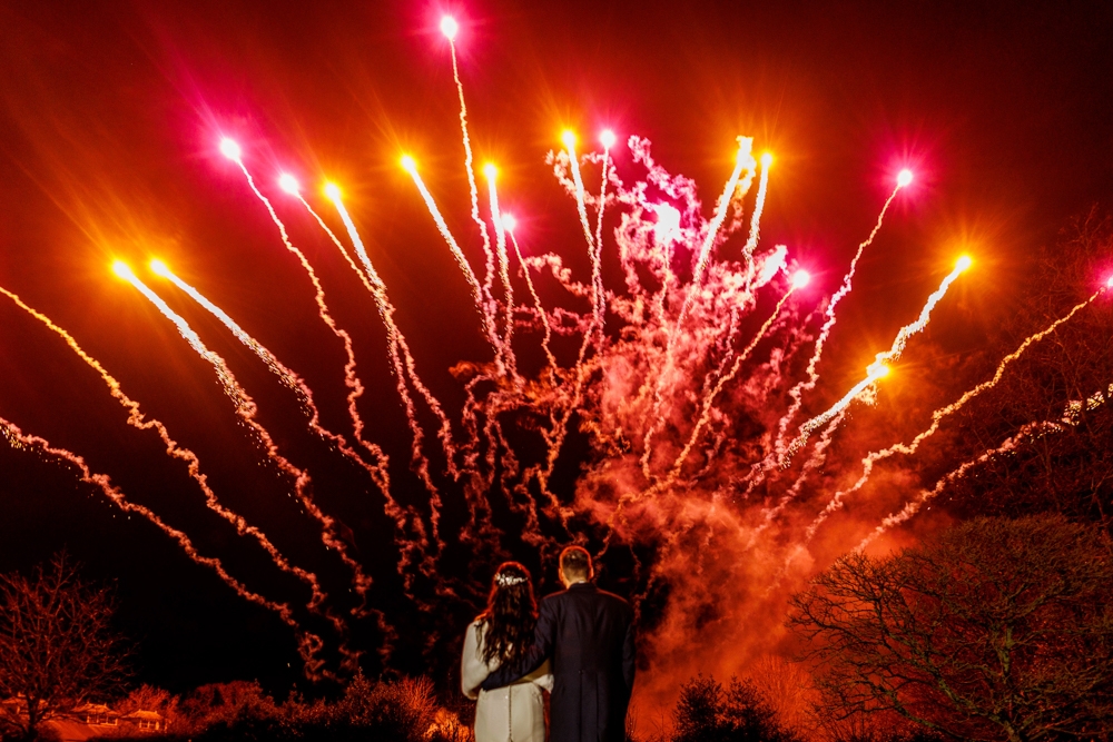 bride and groom watching the fireworks 
