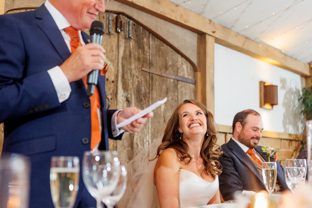 bride laughing at a speech 