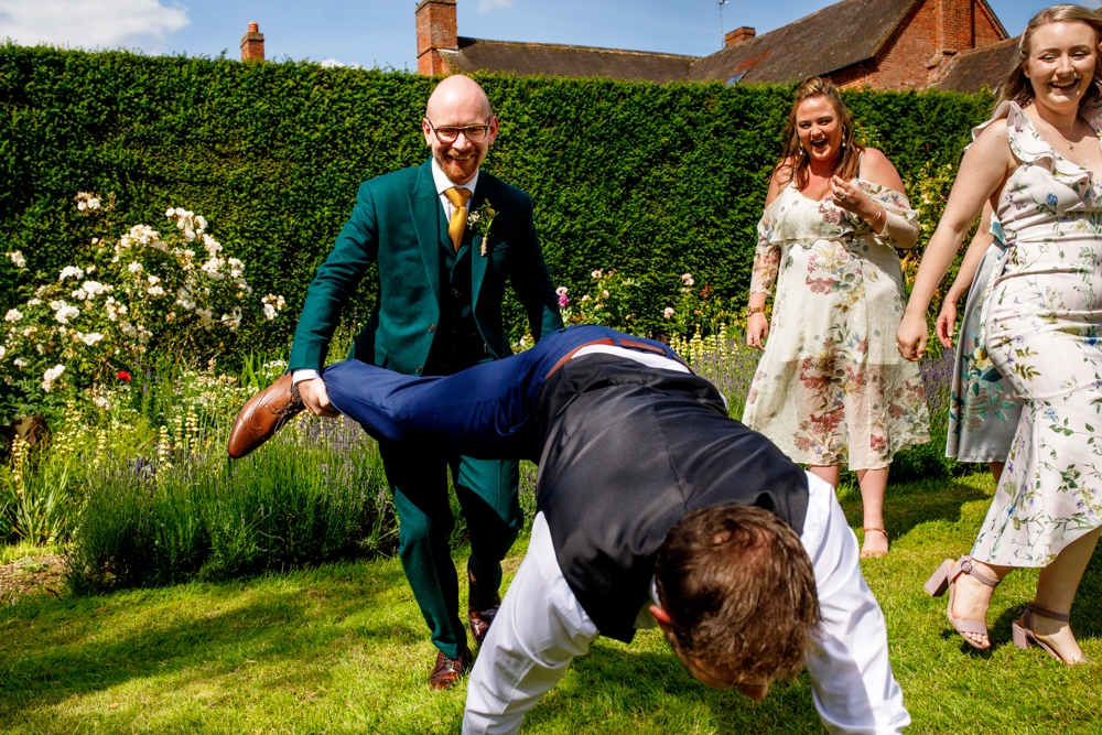 groom in a wheel barrow race