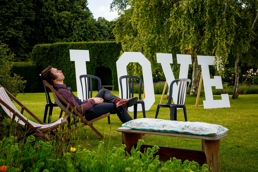 shot of wedding guest asleep in the sun 