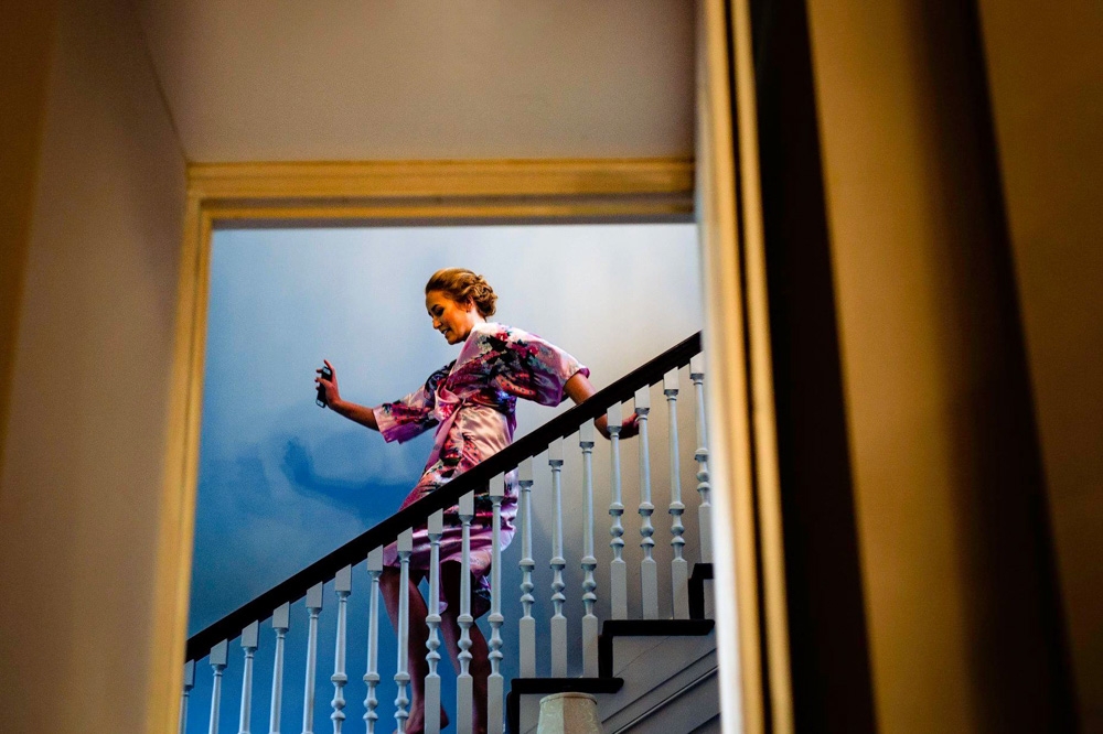 bridesmaid running down the stairs