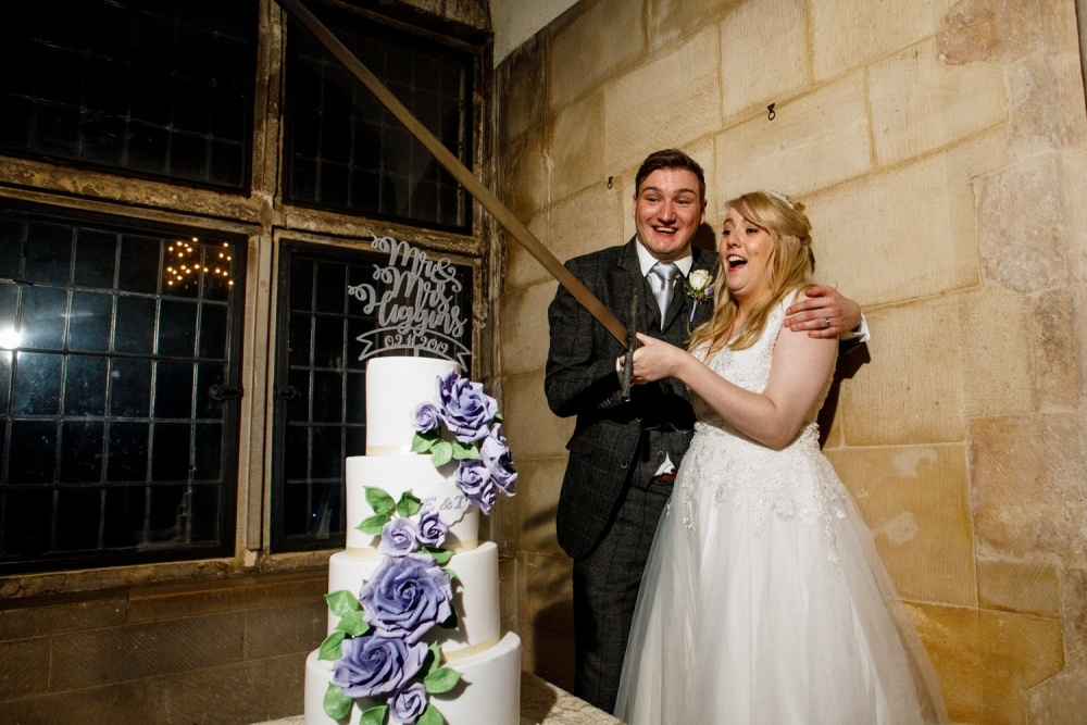 bride and groom cutting the cake