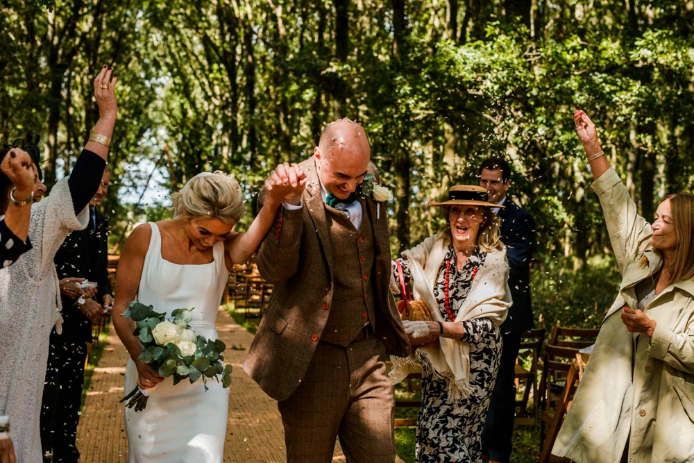 bride and groom being covered in confetti