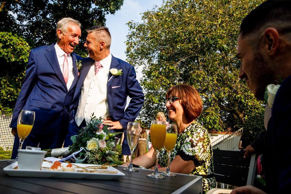 friends laughing during wedding breakfast