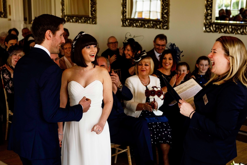 bride and groomlaughing during ceremony