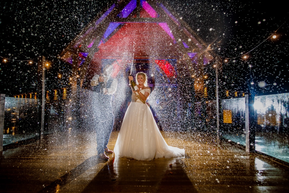 bride and groom spraying champagne