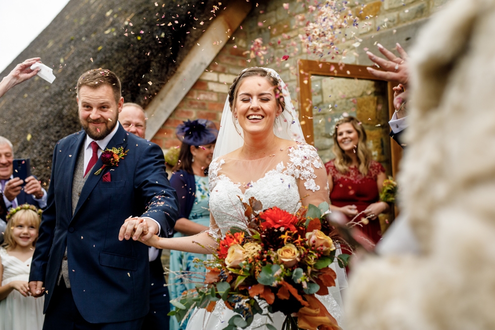 couple walking through confetti throw