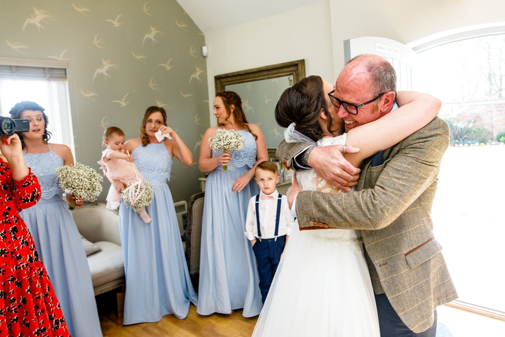 bride and dad hugging