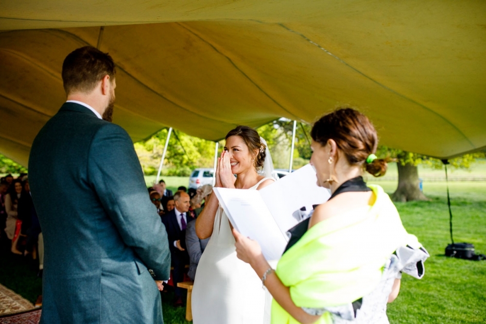 bride and groom laughing during ceremony