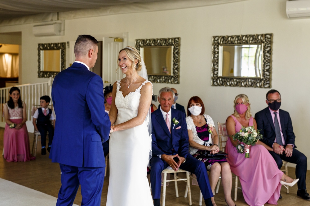 bride and groom laughing at the top of the wedding isle