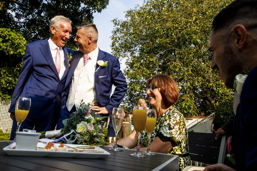 friends laughing during wedding breakfast