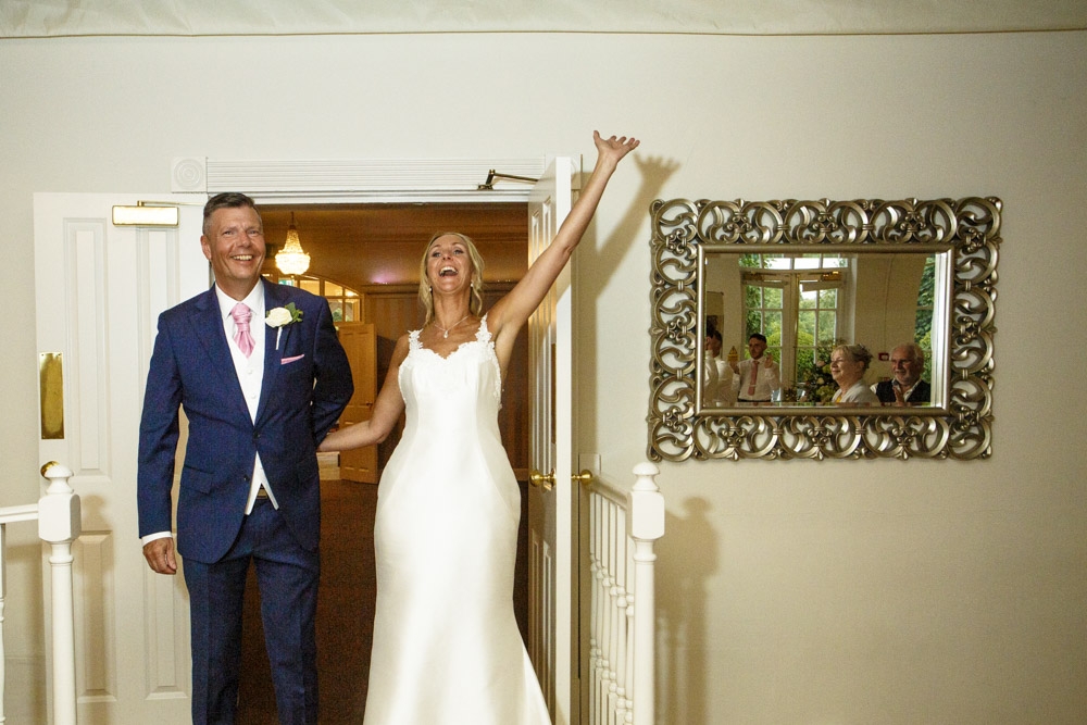 bride and groom entering the wedding breakfast room