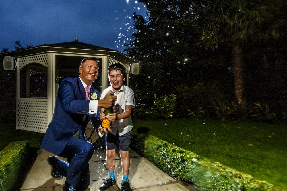 groom spraying champagne