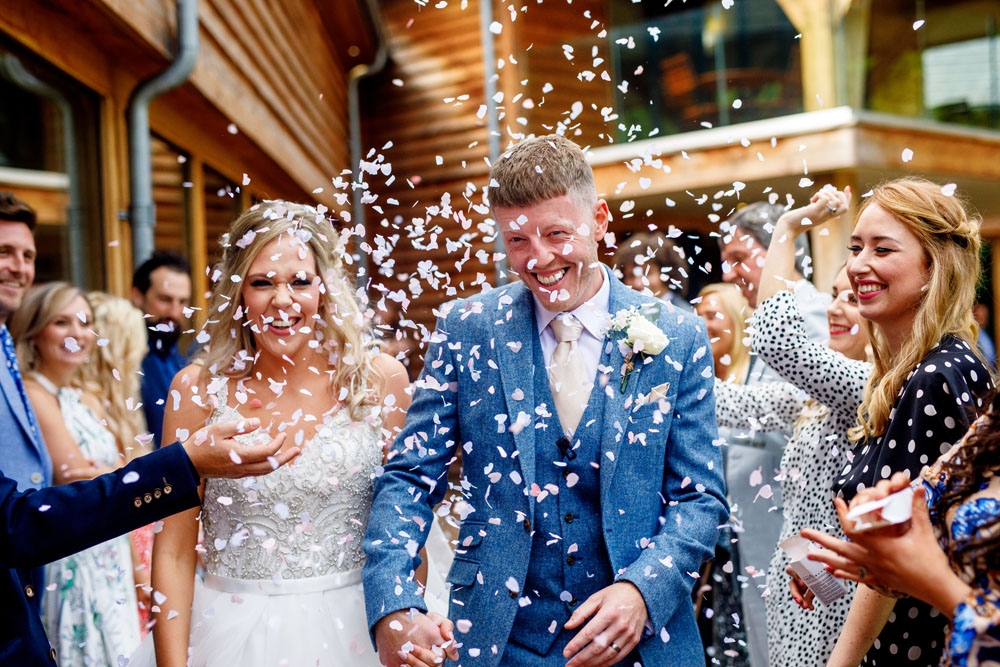 bride and groom covered in confetti