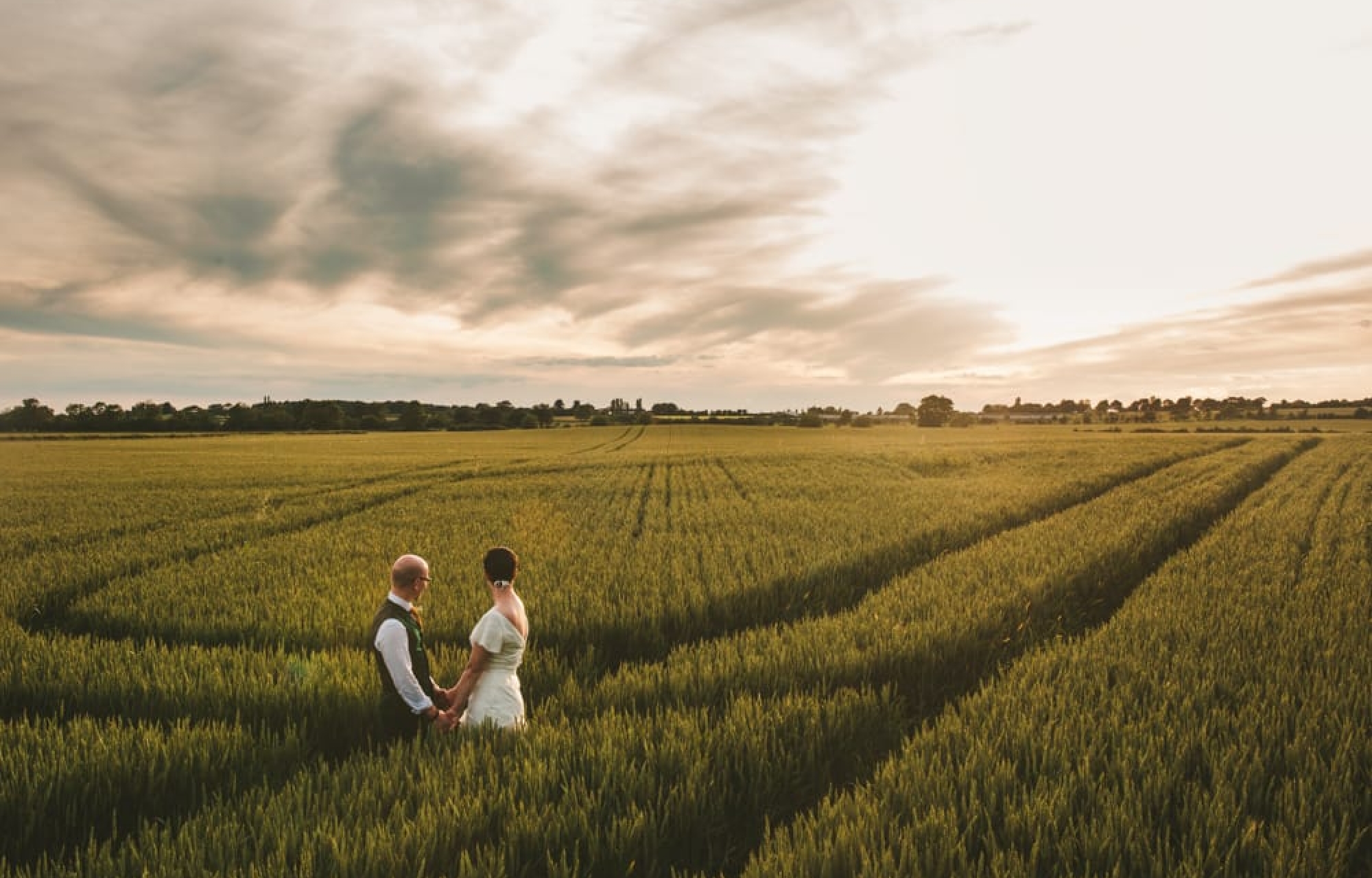 Wedding Couple Holding hands at sunset