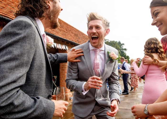 guests laughing during drinks reception