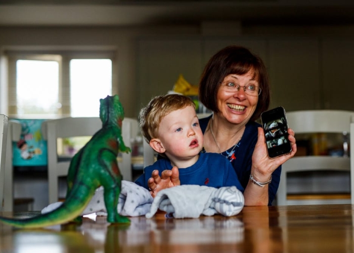 grandma and child playing on the phone